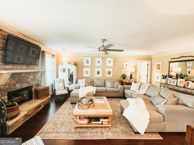 living area with a ceiling fan, dark wood-style flooring, a fireplace, and crown molding