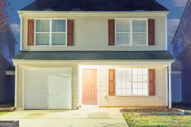 traditional-style home featuring driveway and an attached garage