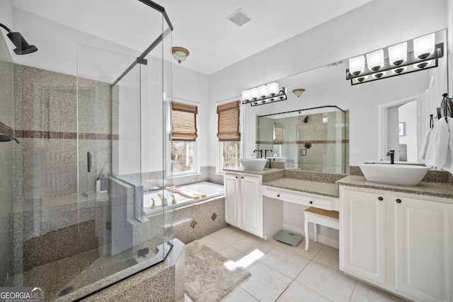 bathroom with visible vents, a shower stall, a bath, tile patterned floors, and a sink