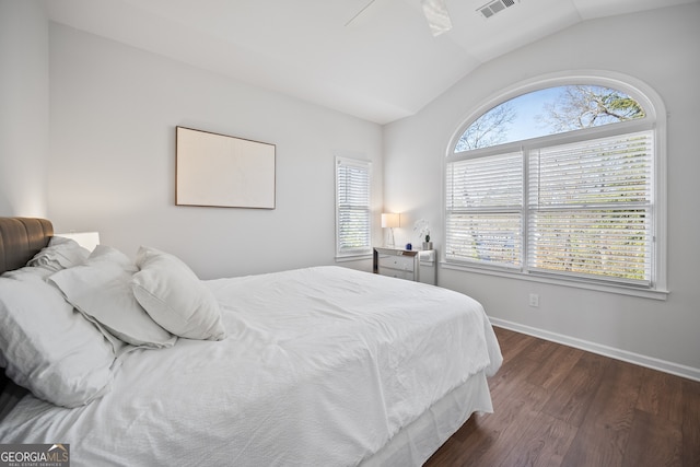 bedroom featuring baseboards, visible vents, lofted ceiling, dark wood-style flooring, and ceiling fan