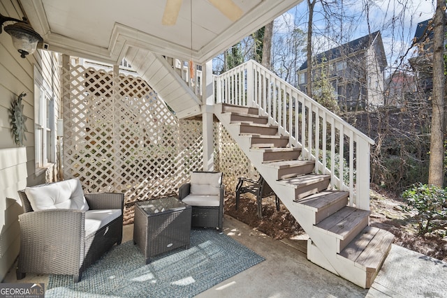 view of patio / terrace with ceiling fan and stairs