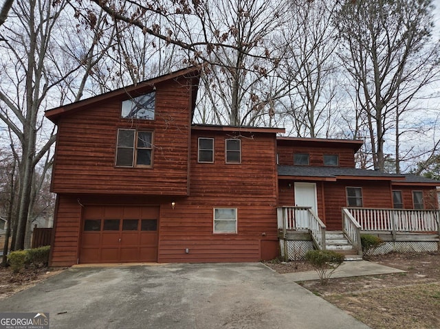 view of front facade with aphalt driveway and an attached garage