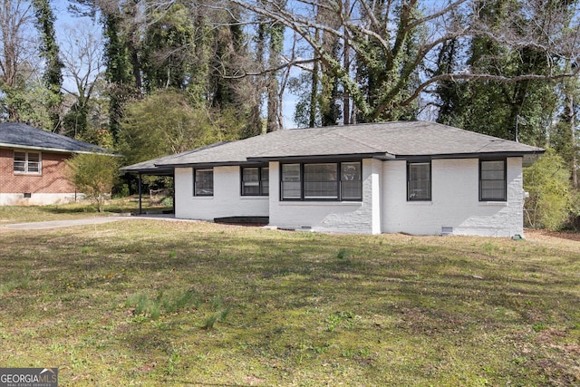 single story home with brick siding, an attached carport, a front lawn, roof with shingles, and crawl space