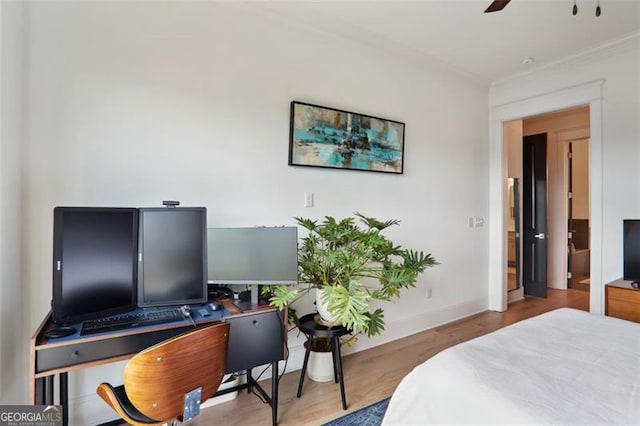 bedroom featuring baseboards, ornamental molding, ceiling fan, and wood finished floors