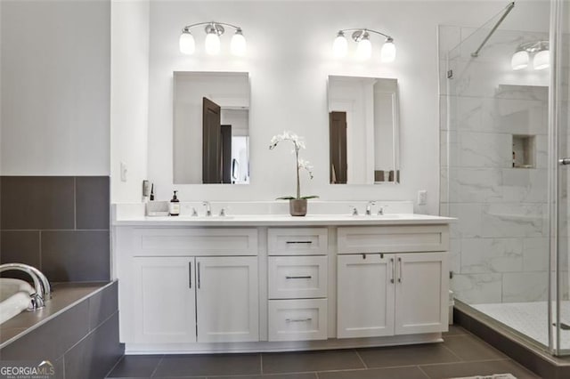 full bathroom featuring a stall shower, a sink, a bath, and double vanity