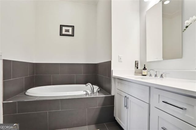 bathroom featuring tile patterned flooring, a bath, and vanity