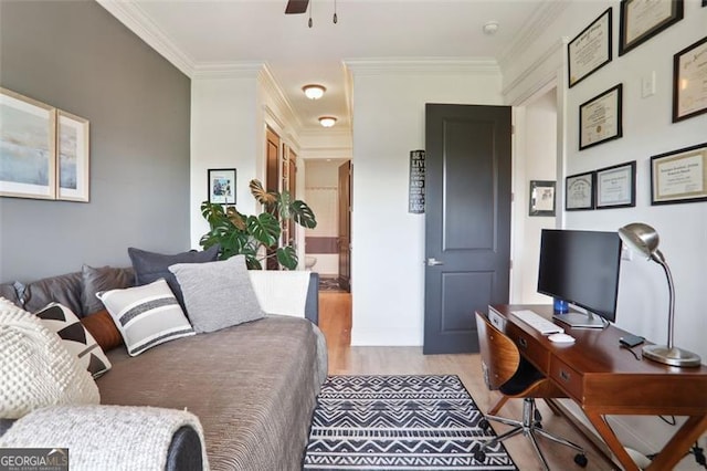 living room with light wood-style floors, a ceiling fan, and crown molding