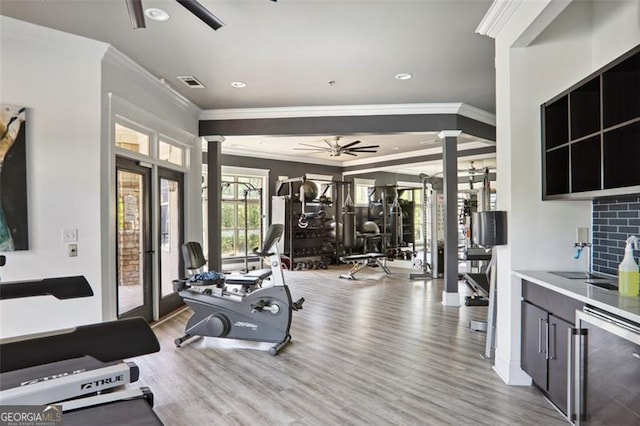 gym featuring ornamental molding, wine cooler, visible vents, and ceiling fan