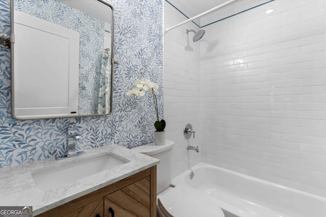 full bathroom featuring shower / bathtub combination, vanity, toilet, and wallpapered walls