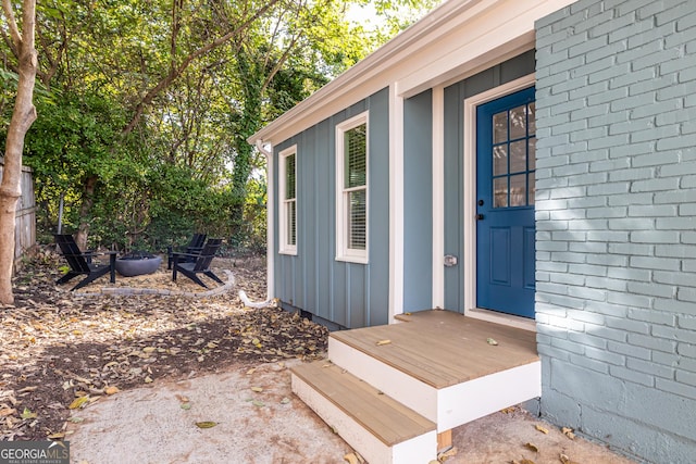 view of exterior entry with board and batten siding