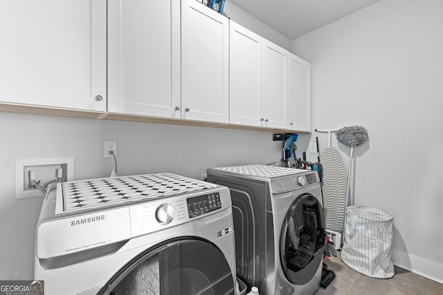 clothes washing area featuring cabinet space, washing machine and dryer, baseboards, and tile patterned flooring