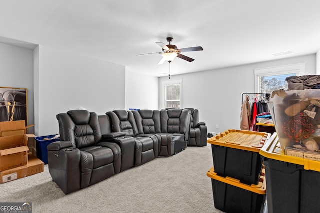 cinema room featuring carpet floors, ceiling fan, and visible vents