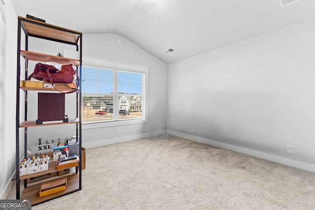 interior space with lofted ceiling, baseboards, and visible vents