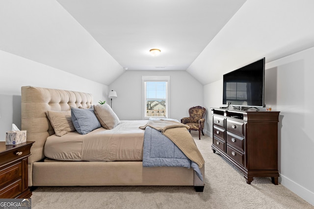 bedroom with light carpet, lofted ceiling, and baseboards