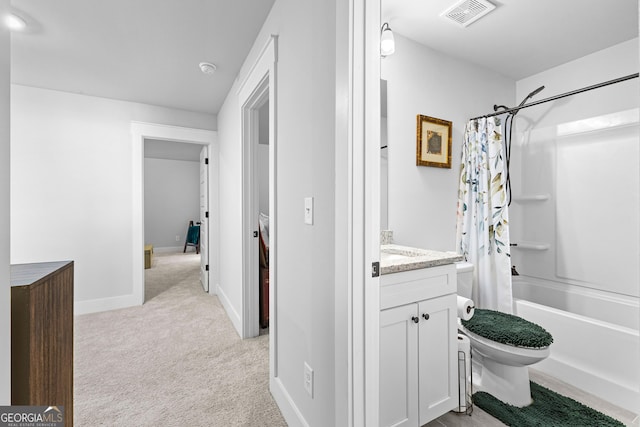 bathroom featuring toilet, vanity, baseboards, visible vents, and shower / tub combo with curtain