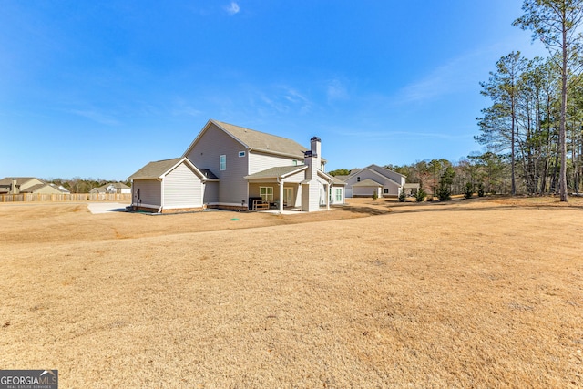 rear view of property with a lawn