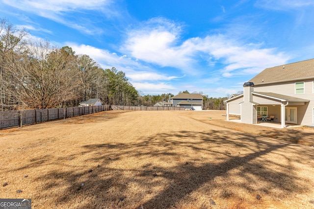 view of yard with a patio area and a fenced backyard