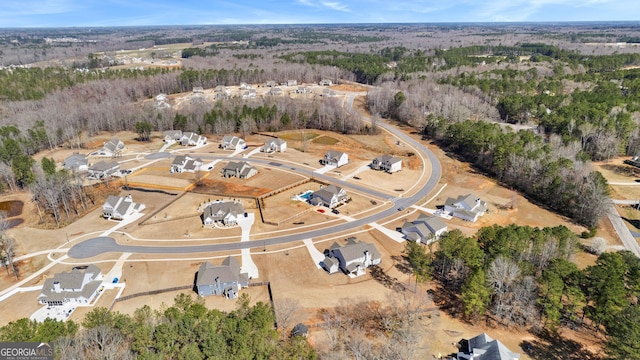 birds eye view of property featuring a wooded view