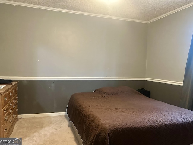 bedroom featuring light carpet, a textured ceiling, baseboards, and crown molding