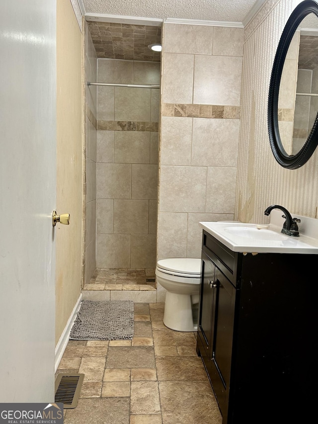 bathroom with toilet, tiled shower, visible vents, and stone tile floors