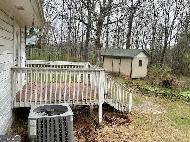 deck with an outbuilding, central AC, and a shed