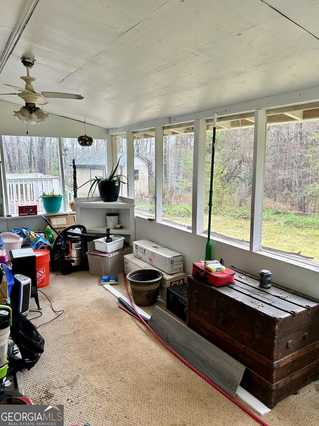 sunroom / solarium featuring ceiling fan