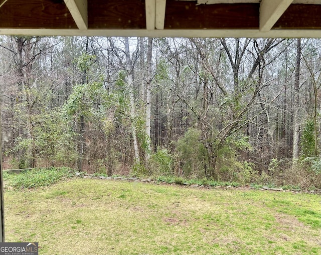 view of yard featuring a view of trees