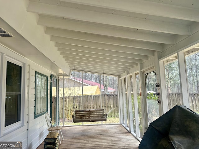 sunroom / solarium featuring visible vents and beamed ceiling