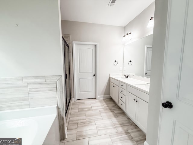 full bathroom featuring double vanity, a garden tub, a shower stall, and visible vents