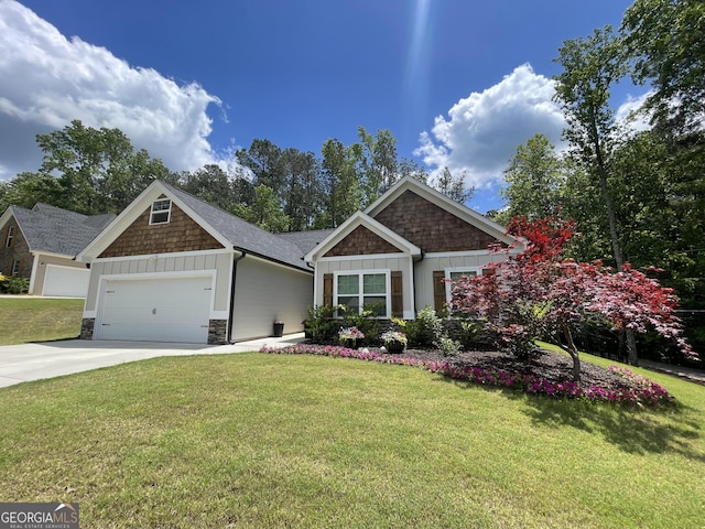 craftsman-style home featuring board and batten siding, a garage, a front lawn, and concrete driveway