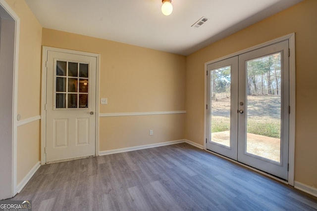 entryway with visible vents, baseboards, wood finished floors, and french doors