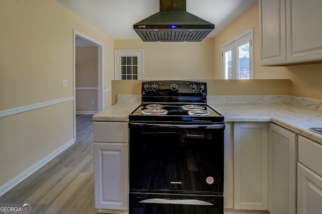 kitchen with black range with electric cooktop, white cabinetry, baseboards, light wood-style floors, and ventilation hood