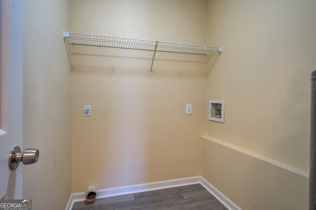 clothes washing area featuring laundry area, baseboards, dark wood-type flooring, hookup for a washing machine, and hookup for an electric dryer