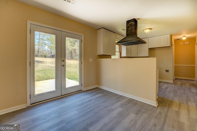 interior space featuring french doors, baseboards, and wood finished floors