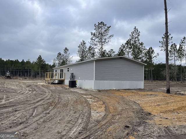 view of home's exterior featuring driveway and central AC