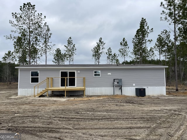 back of property featuring a wooden deck and central AC unit