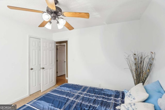 carpeted bedroom with baseboards and a ceiling fan