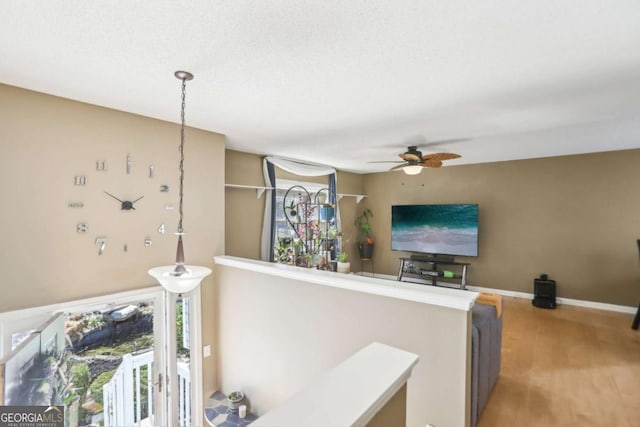 hall featuring light wood-style flooring and baseboards