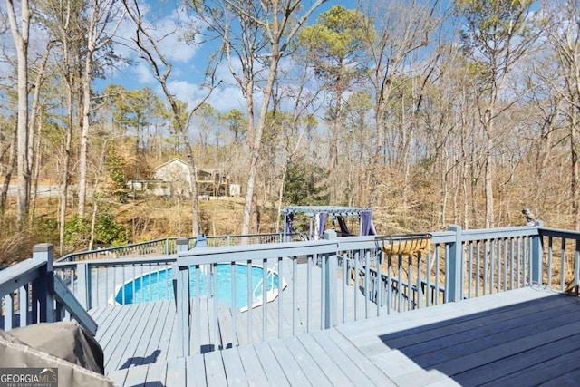 view of swimming pool featuring a fenced in pool and a wooden deck