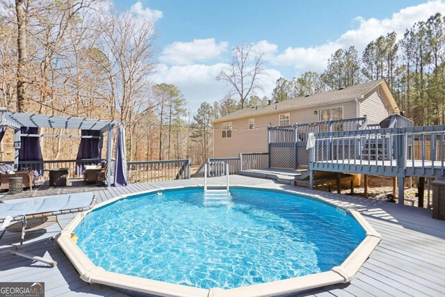 view of pool with a wooden deck