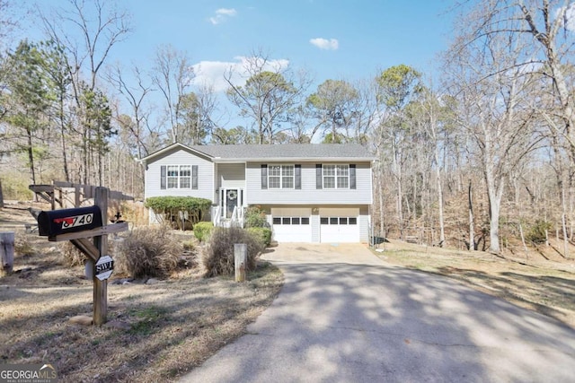 bi-level home featuring an attached garage and concrete driveway