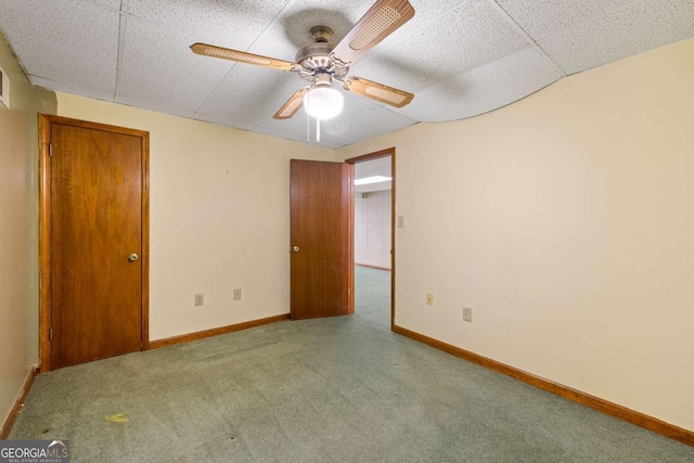 unfurnished bedroom featuring carpet, ceiling fan, and baseboards