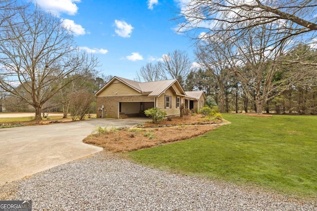 view of front of house with a garage, gravel driveway, metal roof, and a front lawn