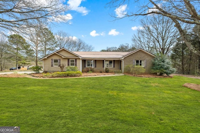 ranch-style home featuring metal roof and a front yard