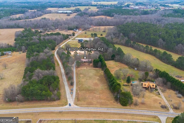 birds eye view of property featuring a rural view