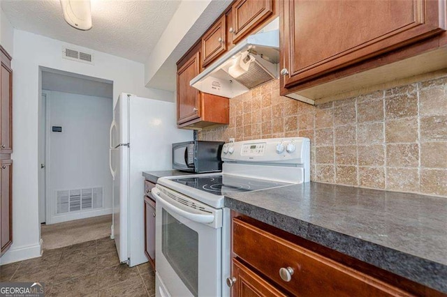 kitchen with visible vents, white electric range, backsplash, black microwave, and under cabinet range hood