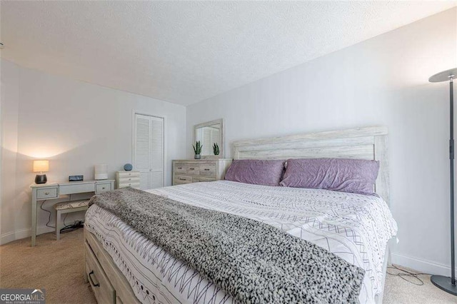 bedroom with light carpet, a closet, baseboards, and a textured ceiling