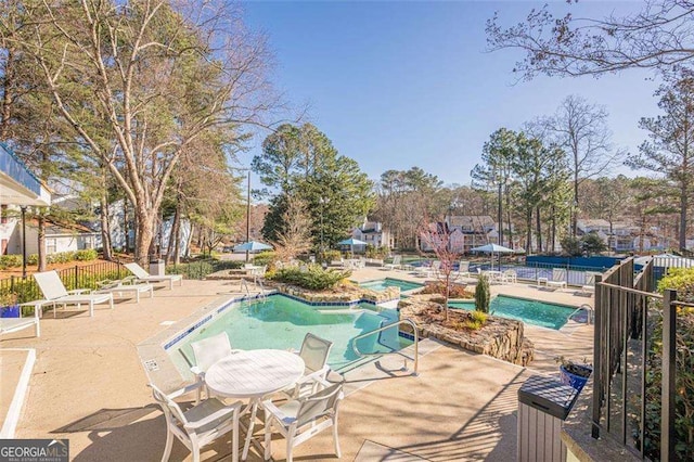 pool featuring a patio area and fence