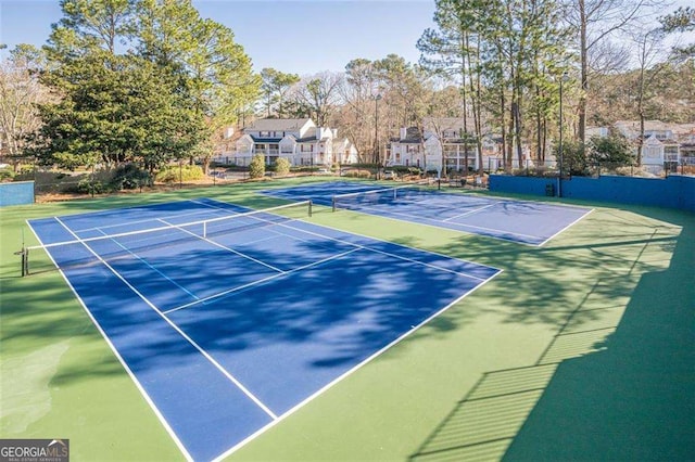 view of tennis court with fence