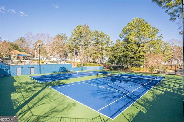 view of sport court featuring fence